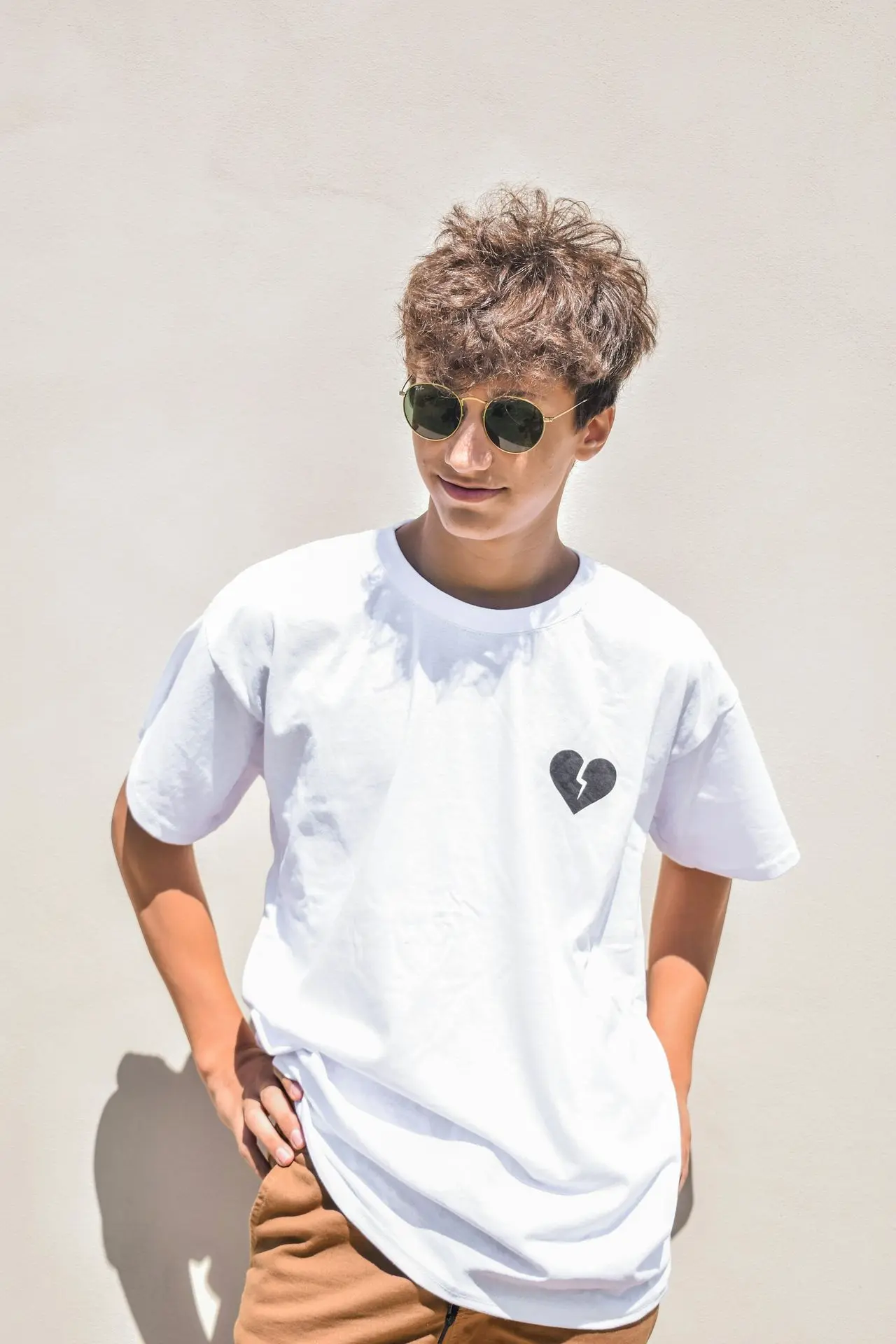 boy in white crew neck t-shirt wearing black sunglasses